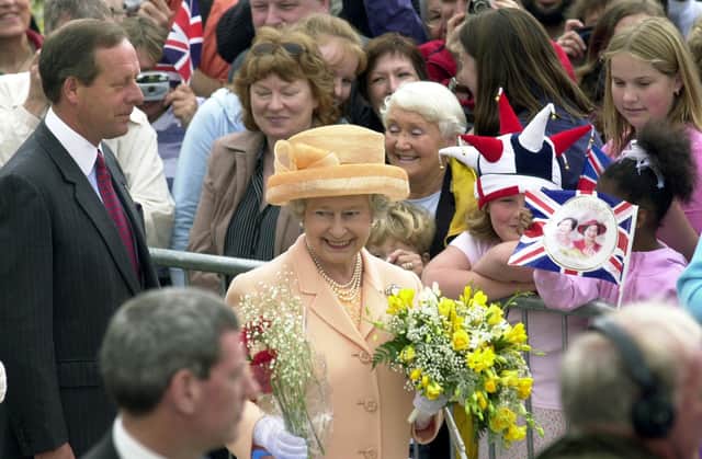 The Queen meets the crowd of well-wishers at Millennium Square.