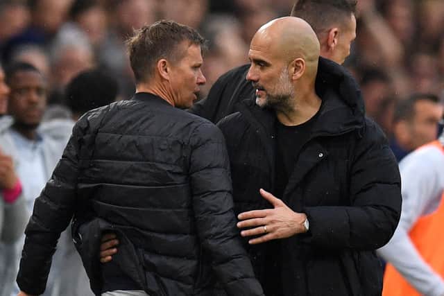 Leeds United head coach Jesse Marsch and Pep Guardiola exchange pleasantries at the final whistle after Man City's 4-0 win at Elland Road (Photo by OLI SCARFF/AFP via Getty Images)