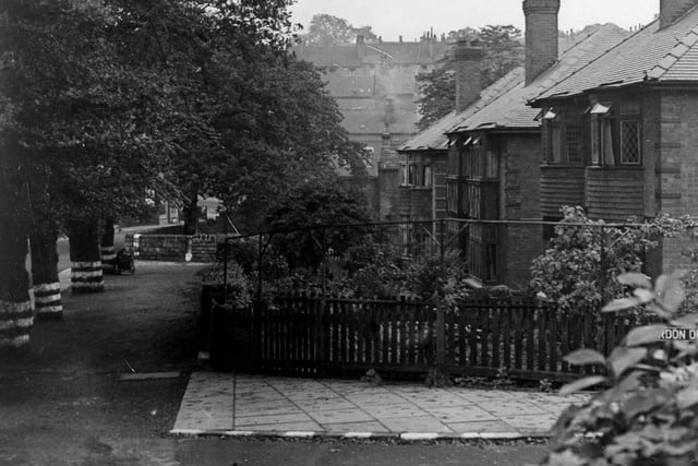 A view looking south-west on Monk Bridge Road in August 1944. Number 73 is the second house along from the right. There is a row of trees along the left hand side of the picture and a child is playing with a pram.