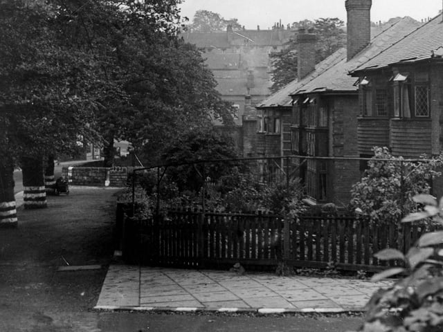 A view looking south-west on Monk Bridge Road in August 1944. Number 73 is the second house along from the right. There is a row of trees along the left hand side of the picture and a child is playing with a pram.