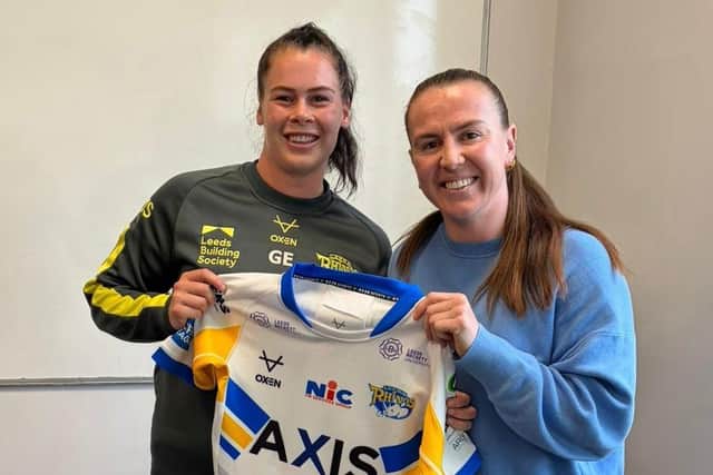 Georgia Elliston, left, receives her Leeds Rhinos debut jersey from New Zealand star Georgia Hale. Picture by Leeds Rhinos.