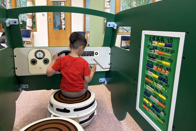 Five-year-old Hakan playing in the refurbished children's outpatients department at Dewsbury and District Hospital