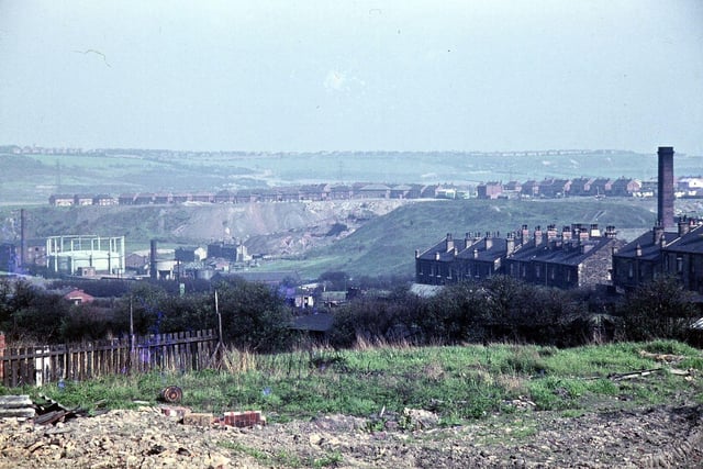 This view from May 1963 looks towards Middleton and was taken from behind where the Albion Mill once stood, before being burned down in a fire in 1950, on the approximate site of the old windmill. Before the Parish Church was built in 1830, Church Street was called Windmill Hill Lane and Chapel Hill was originally Windmill Hill. For many years the windmill was used to grind corn, but about 1780 it was decided to try to run some textile machinery in it like carders and scribblers, though not very successfully. The photograph was taken looking down on Morley gasworks. Behind them is the tip for Morley Main Colliery. On the right is the back of New Bank Street and Crank Mill chimney