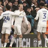 EARLY CONTROVERSY - Leeds United's Patrick Bamford (left) celebrates scoring their side's first goal of the game with team-mates Georginio Rutter (left) and Junior Firpo as Rotherham United protested to the referee over a possible handball Pic: Danny Lawson/PA Wire.