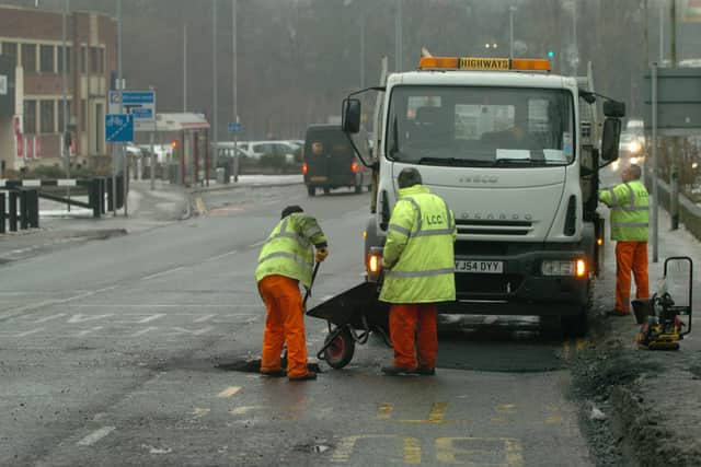 Leeds City Council workers repairing pot holes on Bridge Road, Kirkstall.