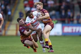 Josh Hodson, left and Batley teammate James Meadows tackle Leigh's Edwin Ipape during a Championship game in 2022. Picture by John Clifton/SWpix.com.