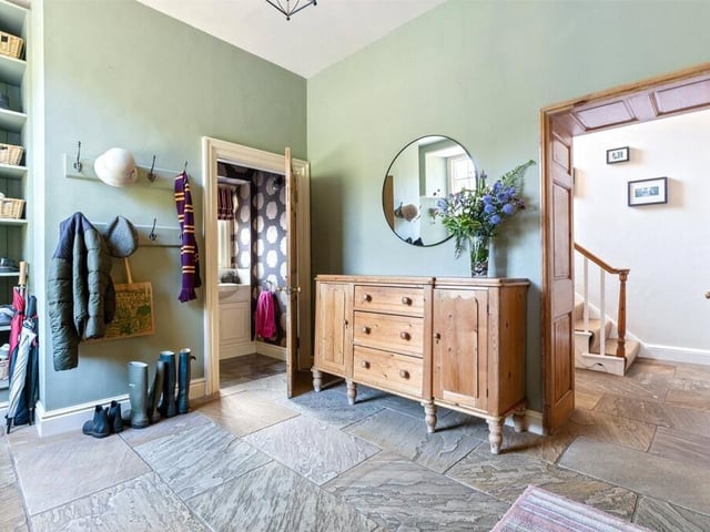A boot room has direct access to the garden with bespoke cabinetry and wc.