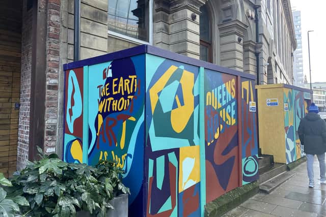 Colourful hoardings designed by artist Mike Winnard currently stand at the front of the building, piquing the interest of curious passers-by.