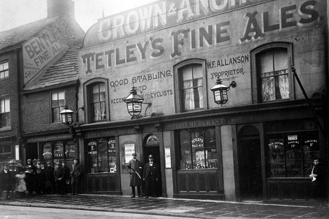 The Crown and Anchor pub on North Street in 1901. The landlord was William Francis Allanson. It served Tetley's Fine Ales. Also advertised are good stabling and accommodation for cyclists. Three ornamental lamps light the building. To the left is the Victoria Inn, serving Bentley's Beer, the sign can be seen on a portion of the gable end wall, landlord N.Hutchinson. To the right, lower premises are dining rooms, business of Mrs Charlotte Ann Dawson. On the right edge is a barbers shop, run by William Williams.