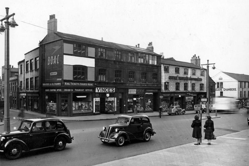 The south side of Park Lane at the junction with Park Cross Street in April 1953. Advertisement hoarding for B.O.A.C. Shops include; Hood's Tourist Office, Vince's Shoe Shop, Crockatt's Dryers and Cleaners, H. Lucas - Tobacco among others