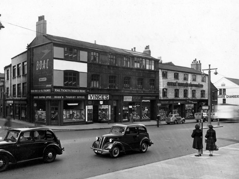 The south side of Park Lane at the junction with Park Cross Street in April 1953. Advertisement hoarding for B.O.A.C. Shops include; Hood's Tourist Office, Vince's Shoe Shop, Crockatt's Dryers and Cleaners, H. Lucas - Tobacco among others