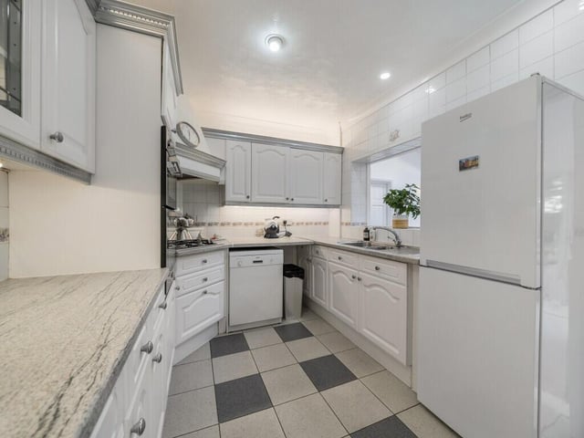 The heart of the home lies to the rear, where a stylish and well-appointed kitchen opens through to an additional dining area.