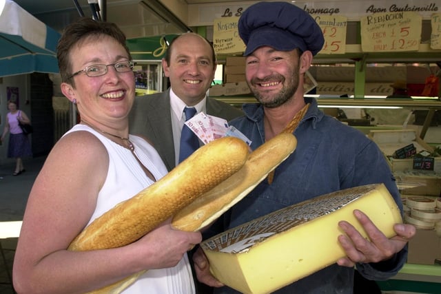Coun Jayne Hill and Morley deputy mayor Neil Dawson pay Philippa Hautbois in Euros at the French market in Morley in July 2002.