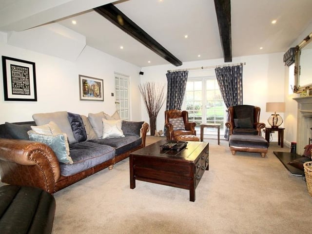 The beamed sitting room within the cottage style property.