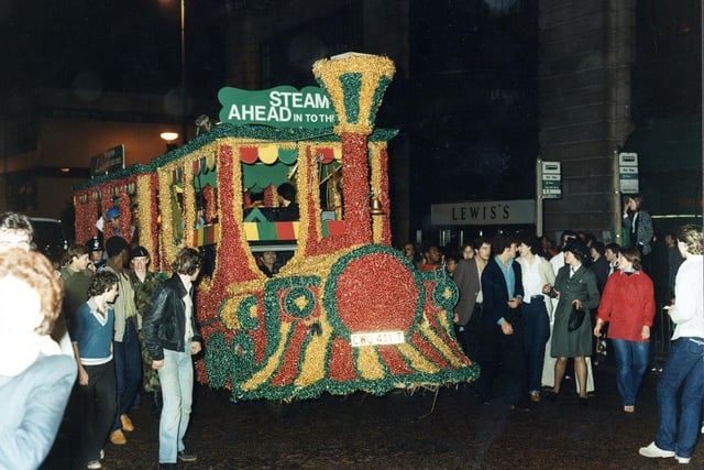 The winning decorated float in the 7th Lord Mayor's Parade in June 1980 seen here in the evening. Lewis's department store on The Headrow is visible in the background. At an evening reception the Lord Mayor presented the Lewis's team with 'The Lord Mayor's Award for the Best Overall Entry'.