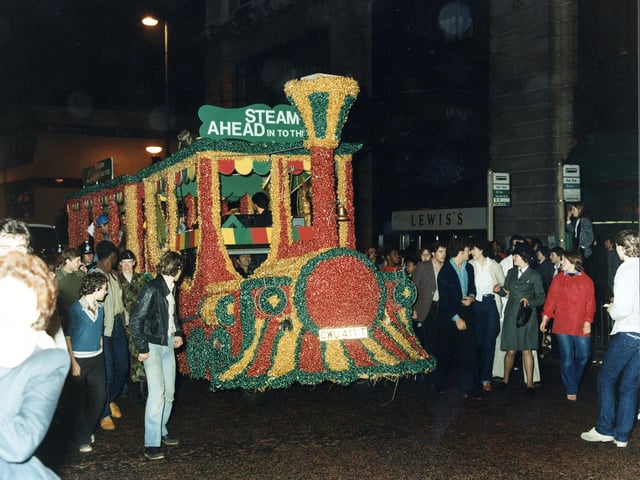The winning decorated float in the 7th Lord Mayor's Parade in June 1980 seen here in the evening. Lewis's department store on The Headrow is visible in the background. At an evening reception the Lord Mayor presented the Lewis's team with 'The Lord Mayor's Award for the Best Overall Entry'.