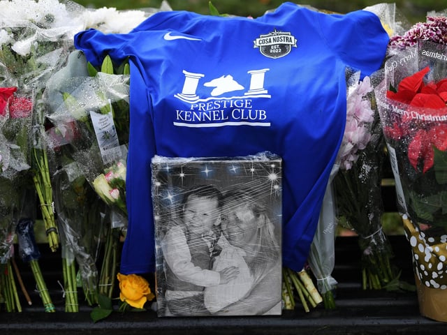 A photo of the 15-year-old boy stands at the centre of tributes to the victim of the reported attack, beside a sea of flowers.