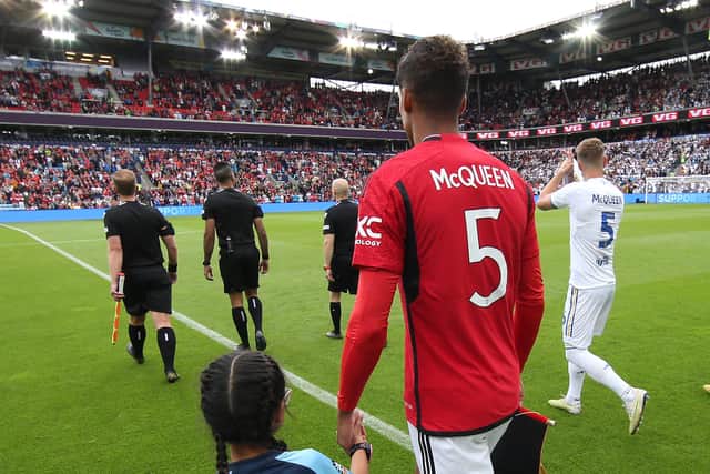 AN HONOUR: Manchester United's Raphael Varane and Leeds United's Liam Cooper lead out the Red Devils and Whites wearing shirts in tribute to Gordon McQueen.
Photo by Matthew Peters/Manchester United via Getty Images.