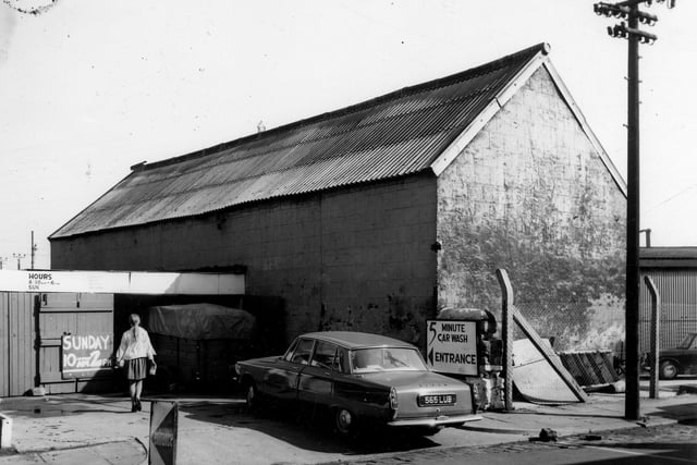 This car wash was part of the Woodside Garage premises which were situated on the corner of Pepper Lane and Low Road. This is the back view from Rocheford Terrace. A notice gives Sunday opening times as 10am to 2pm. A Rover car is parked in view. Pictured in April 1968.