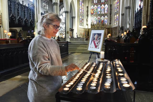 Alison McLennan-Parish lights a candle for Queen Elizabeth II at Leeds Minster. Picture: Steve Riding