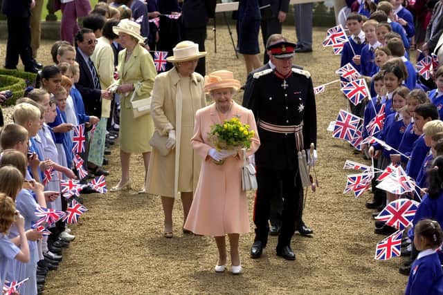 The Queen is welcomed by school children from round West Yorkshire on the Terrace at Harewood House in 2002.