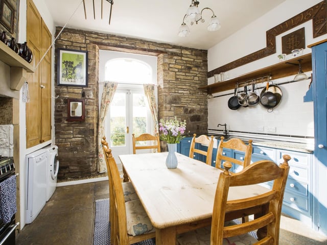 The kitchen with Yorkshire stone floor and original larder cupboard.