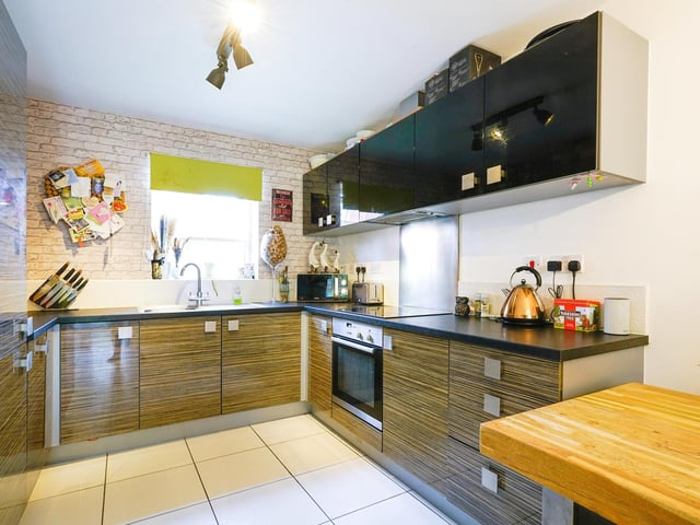 On the ground floor, a tastefully decorated lounge leads into a high gloss kitchen with integrated appliances and french double doors leading to the rear garden.