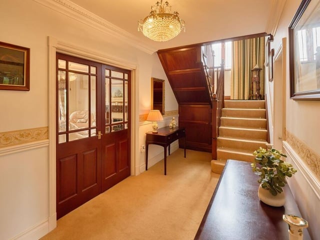 A spacious entrance hall at the centre of the ground floor is home to a regal turned staircase.