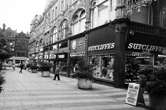 The pedestrianised Queen Victoria Street looking in the direction of Vicar Lane. Pictured in June 1984. Queen Victoria Street has now been closed and is part of the Victoria Quarter. The stained glass roof covering the street was designed by Brian Clarke in 1990 at a cost of £6 million.