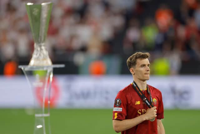 RUNNERS-UP MEDAL: For Leeds United's Diego Llorente, above, with AS Roma as the Whites defender walks past the Europa League trophy which again now lies with Sevilla. 
Photo by ODD ANDERSEN/AFP via Getty Images.