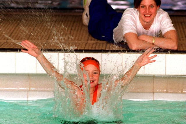 Former Olympic and Commonwealth swimmer Suki Brownsdon watches Jonathan Plows make a splash at the Morley Leisure Centre. Jonathan, a pupil at Gildersome's Birchfield Junior and Infant School , was one of hundreds of local schoolchildren who are taking the plunge at the leisure centre to help raise £200,000 to send British athletes to the 1996 Olympics. Pictured in February 1996.