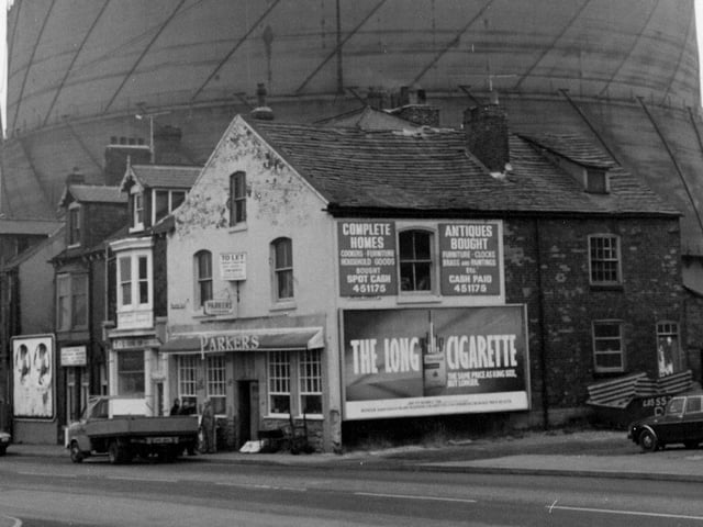 Old properties on Wellington Road. In focus is Parkers dealing in house clearance and antiques. Adjacent is the entrance to Driver Terrace and the gasholder looming in the background is off Driver Street.