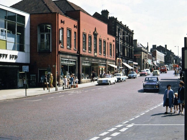 Looking south along Queen Street from the Town Hall corner with Albion Street. Morley Industrial Co-operative Society is still hanging on to Society House and the red-brick Emporium which by this time have been converted into a supermarket. But although the prices of food were reasonably competitive with other supermarkets they could not attract the type of shopper that loads up a car boot full of goods because the buildings lack a car park, and therefore eventually had to close.