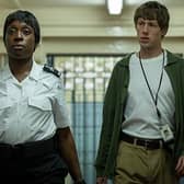 Officer Stephens (Ronke Adekoluejo) and Dan (Josh Finan) make their way through prison in the new BBC drama Waiting for the Out (Picture: BBC/Sister Pictures/Kerry Spicer)
