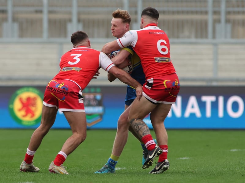 Action from the National League Division One play-off final at Wakefield Trinity as Kieden Hartley and Dave Gibbons of East Leeds tackle Oulton Raiders' Bailey Metcalfe.