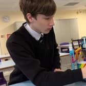 Lighthouse School pupil George Vann demonstrates his biscuit dunking machine. Picture: LocalTV