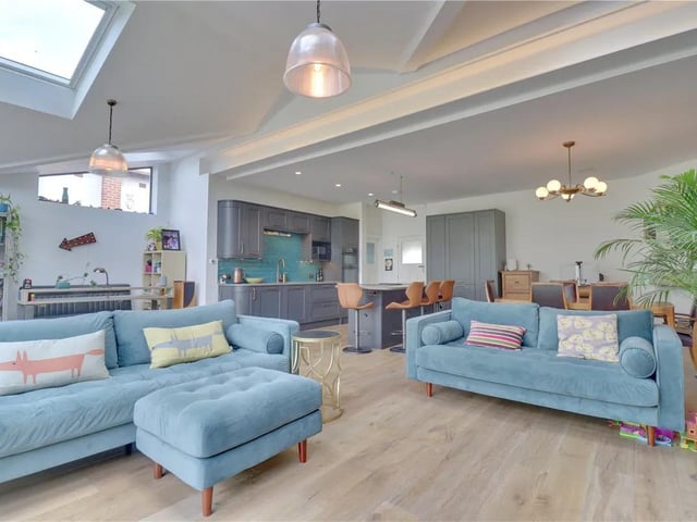 The fitted kitchen has luxury worksurfaces and integrated appliances including a AEG double electric oven, microwave, Elica Induction hob with built in down draft extractor, dishwasher and fridge freezer. The kitchen leads to a spacious utility room with worksurfaces, plumbing for a washing machine and space for a dryer.