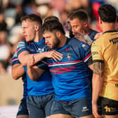 Wakefield Trinity's Matty Storton, second from left, celebrates scoring against Castleford Tigers, but was sent-off soon afterwards. Picture by Alex Whitehead/SWpix.com.