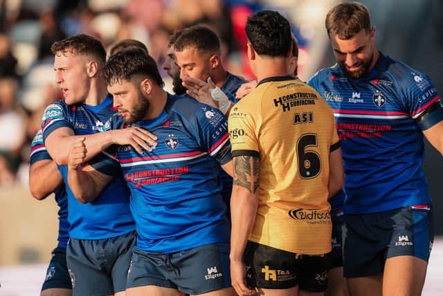Wakefield Trinity's Matty Storton, second from left, celebrates scoring against Castleford Tigers, but was sent-off soon afterwards. Picture by Alex Whitehead/SWpix.com.