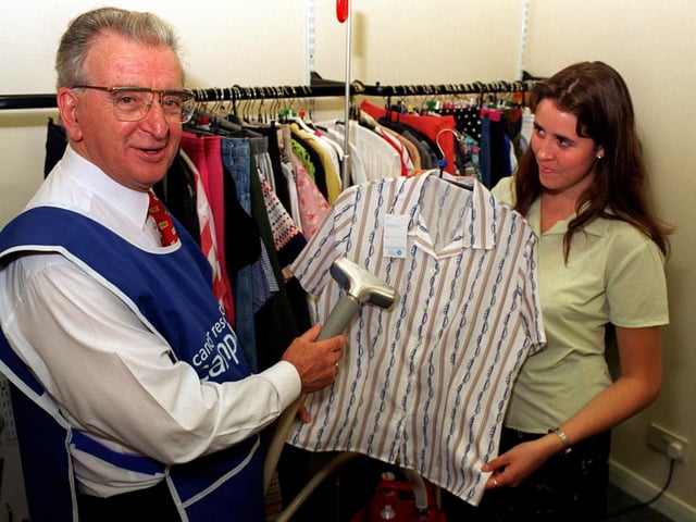 Lord Lofthouse of Pontefract helps volunteer worker Kerrie Moorhouse prepare garments the the Cancer Research Campaign charity shop on Carlton Street in Castleford in August 1997.