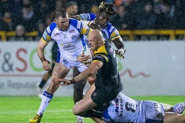 Castleford Tigers' Liam Watts is tackled by Leeds Rhinos' Mikolaj Oledzki, Cameron Smith and Justin Sangare. Picture by Allan McKenzie/SWpix.com.