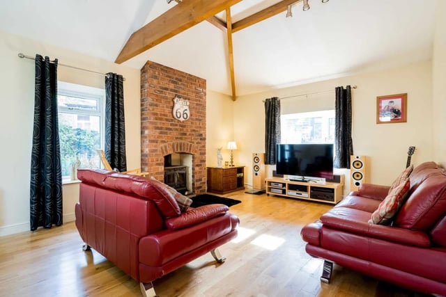 A multi fuel stove cosies up the spacious sitting room with wooden flooring.