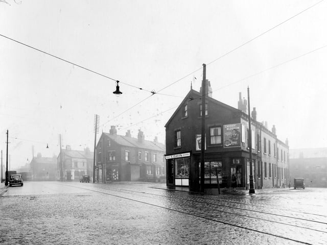 On the left, second block of buildings is a branch of Yorkshire Penny Bank pictured in November 1938. It opened on June 1, 1931. Moving right is the junction with Raincliffe Street, then Leonard Dean, newsagents shop and William Dawson, draper. Next is the junction with Everleigh Street. No.190, premises of E.Davis, family butcher, next no.188 John Redmans' fruit shop. An advertisement for Cherry Blossom shoe polish is over the shop door. Street in view is Chantrell Grove.