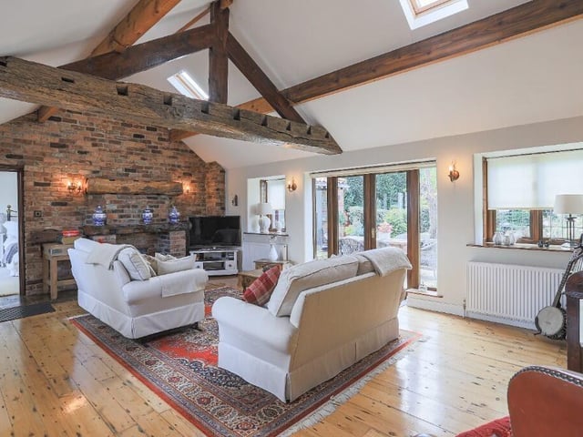 Inside, the home is filled with character features, including exposed beams, vaulted ceilings, and a striking feature well set in the hallway - a beautiful reminder of the property's heritage.