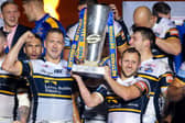 Leeds Rhinos' Danny McGuire and Rob Burrow lift the Super League trophy after the 2017 Grand Final win against Castleford Tigers.