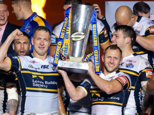 Leeds Rhinos' Danny McGuire and Rob Burrow lift the Super League trophy after the 2017 Grand Final win against Castleford Tigers.