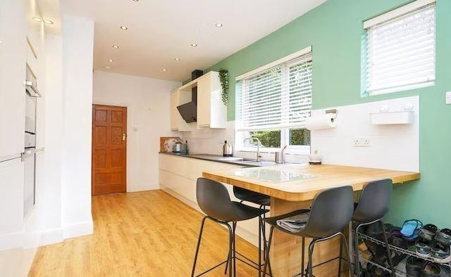 The property features a high gloss kitchen with integrated appliances and breakfast bar.