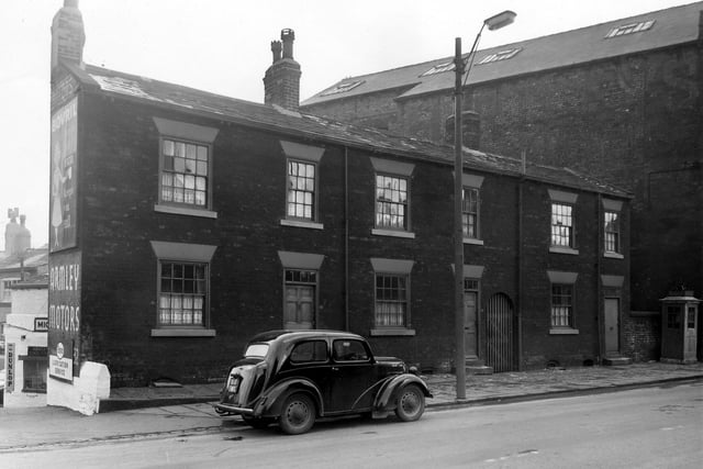 Armley Motors garage on Stanningley Road in  March 1958 offering the Esso lubrication service. An advertisement visible on the gable end of the houses promotes Bovril.