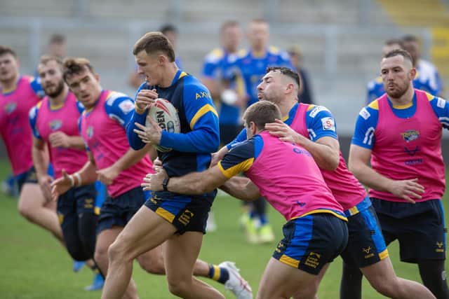 Ash Handley, with ball, will share the Leeds Rhinos captaincy with Cameron Smith, right of picture, this season. Picture by Tony Johnson.