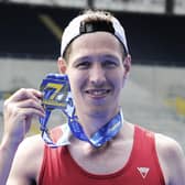 Nathan Edmondson with his medal after becoming the first runner to complete the Rob Burrow Leeds Marathon.